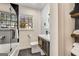 This bathroom has stylish black and white tiling and a shower/bathtub combination at 1471 Hardin Ave, College Park, GA 30337