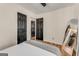 A cozy bedroom featuring hardwood floors and black paneled doors, offering a modern touch to the space at 1471 Hardin Ave, College Park, GA 30337