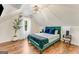 This bedroom features a vaulted ceiling, hardwood floors, a queen bed, and a decorative light fixture at 1471 Hardin Ave, College Park, GA 30337