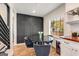 Bright dining area featuring modern accent wall, hardwood floors, and plenty of natural light at 1471 Hardin Ave, College Park, GA 30337