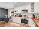 Bright kitchen featuring modern appliances, white cabinetry, wood countertops, and hardwood floors at 1471 Hardin Ave, College Park, GA 30337