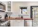 Bright kitchen featuring modern appliances, white cabinetry, wood countertops, and hardwood floors at 1471 Hardin Ave, College Park, GA 30337