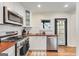 Bright kitchen featuring modern appliances, white cabinetry, wood countertops, and hardwood floors at 1471 Hardin Ave, College Park, GA 30337