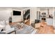 Open-concept living space with modern design, hardwood floors, and a glimpse of the kitchen at 1471 Hardin Ave, College Park, GA 30337