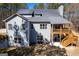 Back exterior view of a two-story home with a spacious deck and a partially covered patio area at 624 Bexley Rd, Moreland, GA 30259