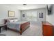 Comfortable bedroom features a wood-frame bed, soft carpet, and neutral walls at 624 Bexley Rd, Moreland, GA 30259