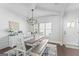 Dining area with a stylish table, bench seating, and elegant decor, next to the front door at 624 Bexley Rd, Moreland, GA 30259