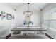 Bright dining room with high ceilings, featuring a rustic table and a modern chandelier at 624 Bexley Rd, Moreland, GA 30259