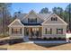 Charming craftsman-style home featuring a covered front porch with rocking chairs and a landscaped front yard at 624 Bexley Rd, Moreland, GA 30259
