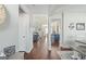 Hallway featuring wood floors, neutral paint, and views into the living room and kitchen areas at 624 Bexley Rd, Moreland, GA 30259