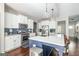 Modern kitchen featuring stainless steel appliances, a center island with seating, and stylish light fixtures at 624 Bexley Rd, Moreland, GA 30259