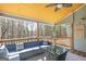 Relaxing screened-in porch with a wood ceiling, ceiling fan, and wooded view at 624 Bexley Rd, Moreland, GA 30259