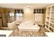Bathroom with a soaking tub, walk in shower, tile floors, and built in shelving at 230 White Rd, Fayetteville, GA 30214