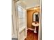 Bathroom with a pedestal sink, decorative mirror, and a storage niche at 230 White Rd, Fayetteville, GA 30214