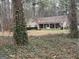 Charming single-Gathering home with a welcoming front porch, nestled among mature trees and natural surroundings at 230 White Rd, Fayetteville, GA 30214