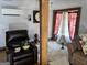 Living Room featuring a wood support beam, leather recliner, and layered curtains at 230 White Rd, Fayetteville, GA 30214