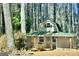 Charming outbuilding featuring a green roof, wooden siding, and a cozy front porch at 230 White Rd, Fayetteville, GA 30214