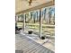Inviting covered front porch featuring wood flooring, columns, and a serene view of the front yard at 230 White Rd, Fayetteville, GA 30214
