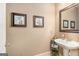 Cozy powder room showcases a pedestal sink and framed floral wall art at 1209 Persimmon Way, Mcdonough, GA 30252