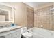 Tiled bathroom featuring an undermount sink, vanity, and bathtub with shower at 1209 Persimmon Way, Mcdonough, GA 30252