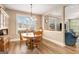Inviting dining area with wood floors, large window, and natural light at 1209 Persimmon Way, Mcdonough, GA 30252
