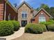 Charming home with a stone and brick facade, arched windows, and beautifully manicured landscaping at 1209 Persimmon Way, Mcdonough, GA 30252