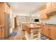 Open-concept kitchen with stainless steel appliances, granite counters, and wood floors at 1209 Persimmon Way, Mcdonough, GA 30252