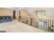 Open loft area with railing overlooking the lower level and comfortable seating at 1209 Persimmon Way, Mcdonough, GA 30252