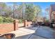 Outdoor patio area with brick retaining wall and firepit at 1209 Persimmon Way, Mcdonough, GA 30252