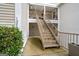 Exterior view of a townhouse featuring stairs leading to an upper unit and well-kept landscaping at 1379 Keys Lake Ne Dr, Brookhaven, GA 30319