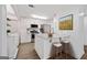 Modern kitchen featuring white cabinets, stainless steel appliances, granite countertops, and two bar stools at kitchen island at 1379 Keys Lake Ne Dr, Brookhaven, GA 30319