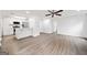 Bright, open-concept living room and kitchen area with modern ceiling fan, stainless steel appliances, and wood-look flooring at 1379 Keys Lake Ne Dr, Brookhaven, GA 30319