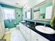 Bright bathroom features a double sink vanity with a dark countertop and decorative mirrors at 114 Rolling Grn, Peachtree City, GA 30269