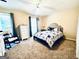 Comfortable bedroom featuring a plush bed, a rocking chair, and natural light from a bright window at 114 Rolling Grn, Peachtree City, GA 30269