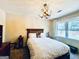 Well-lit bedroom features a cozy bed with a wooden headboard, and a unique antler-style chandelier at 114 Rolling Grn, Peachtree City, GA 30269