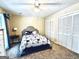 Cozy bedroom featuring a plush bed with a decorative headboard, and a spacious closet for ample storage at 114 Rolling Grn, Peachtree City, GA 30269