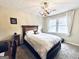 Well-lit bedroom features a cozy bed with a wooden headboard, and a large window for natural light at 114 Rolling Grn, Peachtree City, GA 30269