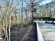 View of the wooden deck with pergola and white railings surrounded by trees, offering a serene outdoor space at 114 Rolling Grn, Peachtree City, GA 30269