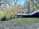 Wooden deck with white railings overlooking the yard and trees, providing a relaxing outdoor retreat at 114 Rolling Grn, Peachtree City, GA 30269
