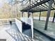 Spacious wooden deck with pergola, white railings and steps leading down to the backyard for outdoor enjoyment at 114 Rolling Grn, Peachtree City, GA 30269