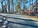 Paved driveway leading to the home with mature landscaping at 114 Rolling Grn, Peachtree City, GA 30269