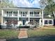 Charming two-story home with a double porch, black shutters, and lovely landscaped yard at 114 Rolling Grn, Peachtree City, GA 30269