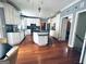 Bright kitchen featuring white cabinetry, dark countertops, and an island with wood floors at 114 Rolling Grn, Peachtree City, GA 30269