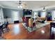 Bright living room with hardwood floors, fireplace, ceiling fans, and large windows at 114 Rolling Grn, Peachtree City, GA 30269