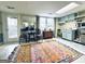 Cozy living room featuring an colorful area rug, table set, kitchenette, and walkout door at 114 Rolling Grn, Peachtree City, GA 30269