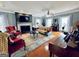Inviting living room features hardwood floors, a stone fireplace, and colorful area rug at 114 Rolling Grn, Peachtree City, GA 30269