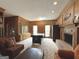 Spacious living room with wood paneling, a fireplace, and built-in bookcase at 114 Rolling Grn, Peachtree City, GA 30269