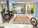 Cozy living room with colorful area rug, kitchenette, and view to the hallway at 114 Rolling Grn, Peachtree City, GA 30269