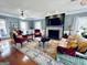 Spacious living room with a fireplace, hardwood floors, and ample seating at 114 Rolling Grn, Peachtree City, GA 30269