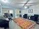 Open-concept living room with an area rug, seating area, and ceiling fan at 114 Rolling Grn, Peachtree City, GA 30269